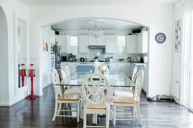 a view of a kitchen with dining table and chairs