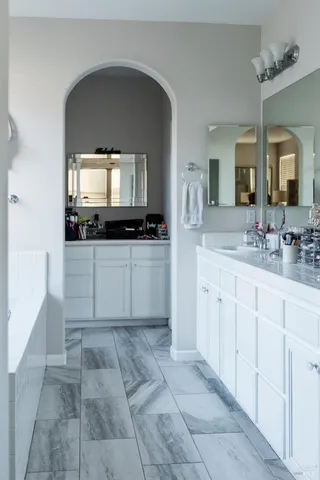 a kitchen with sink and view of living room