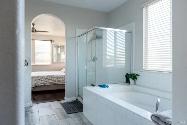 a white toilet sitting next to a shower