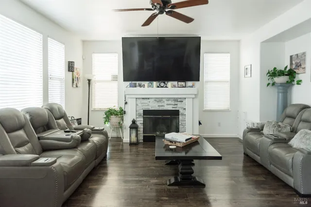 a living room with furniture fireplace and flat screen tv