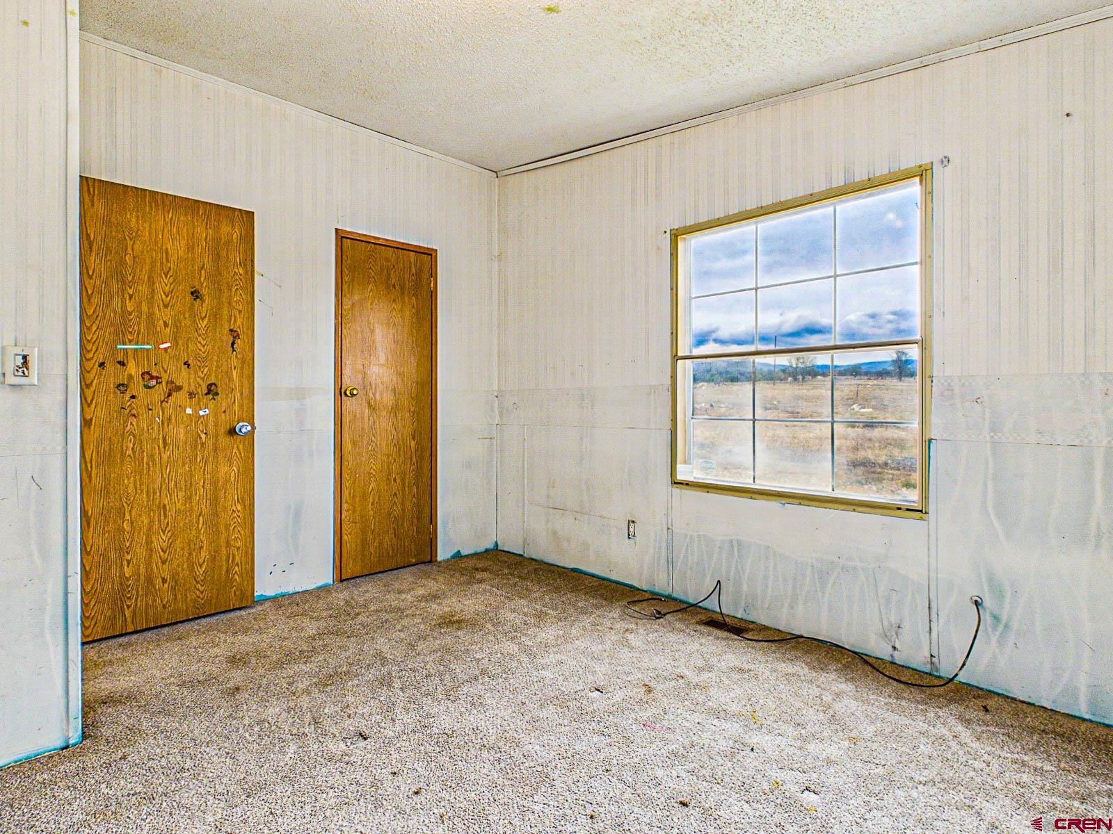 15484 Peach Road Cedaredge, CO 81413 - Photo 21 of 35 an empty room with windows