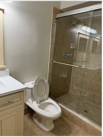 a bathroom with a toilet and a shower