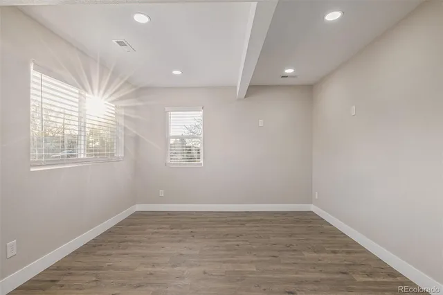 wooden floor in an empty room with a window