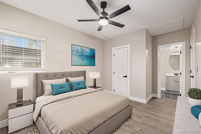 a bedroom with a bed and a painting on the wall