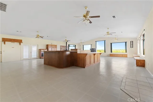 a living room with furniture and a kitchen view