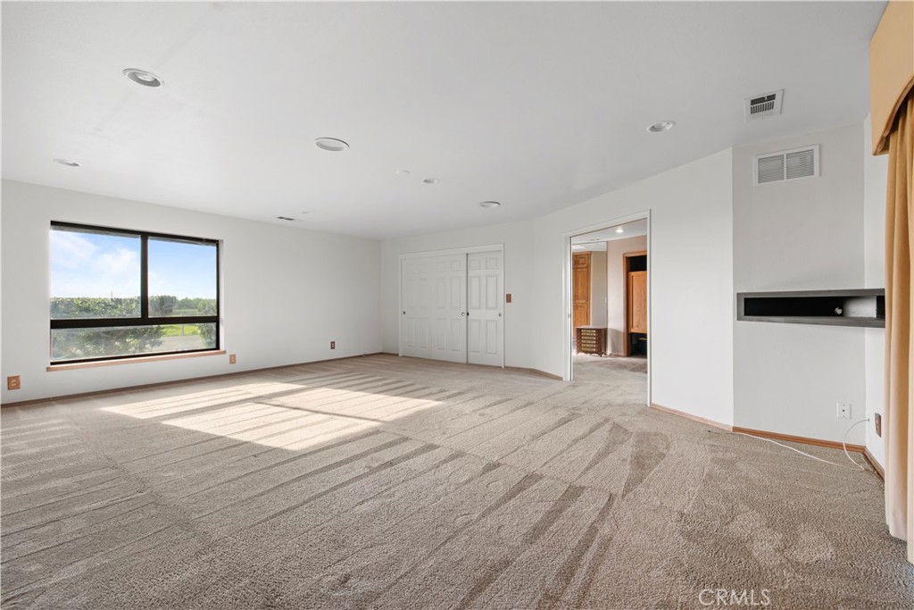 6922 G Street Merced, CA 95340 - Photo 24 of 39 a view of an empty room with wooden floor and a window