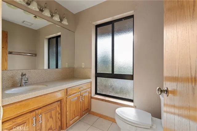 a spacious bathroom with a granite countertop sink toilet and shower