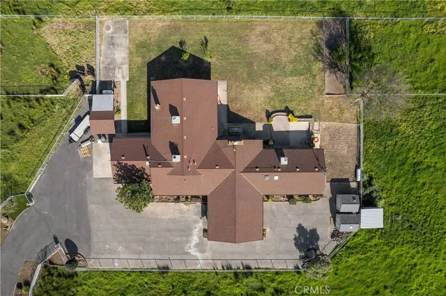 an aerial view of a house with a yard and lake view