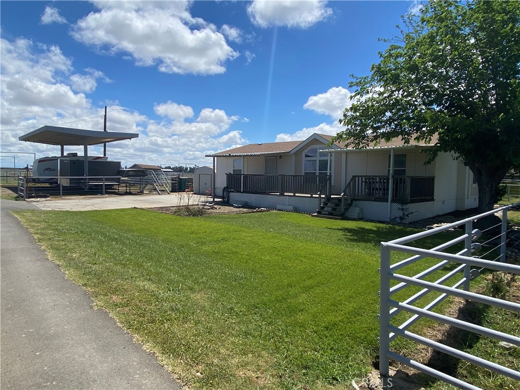 6922 G Street Merced, CA 95340 - Photo 37 of 39 a view of a house with a backyard and sitting area