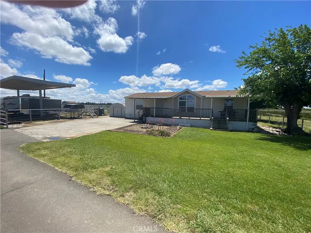 a view of a house with a backyard porch and sitting area