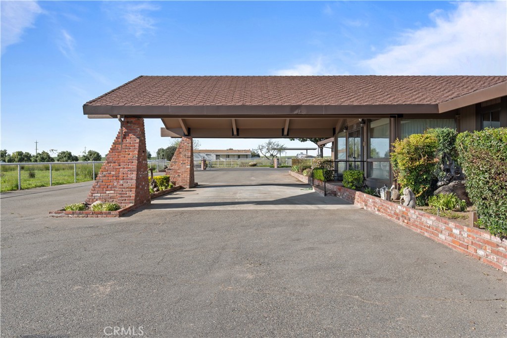 6922 G Street Merced, CA 95340 - Photo 4 of 39 a view of a patio with a table and chairs under an umbrella