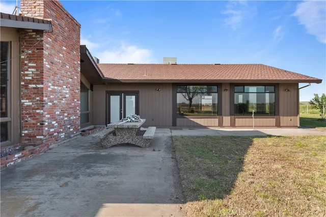a view of a house with backyard porch and sitting area