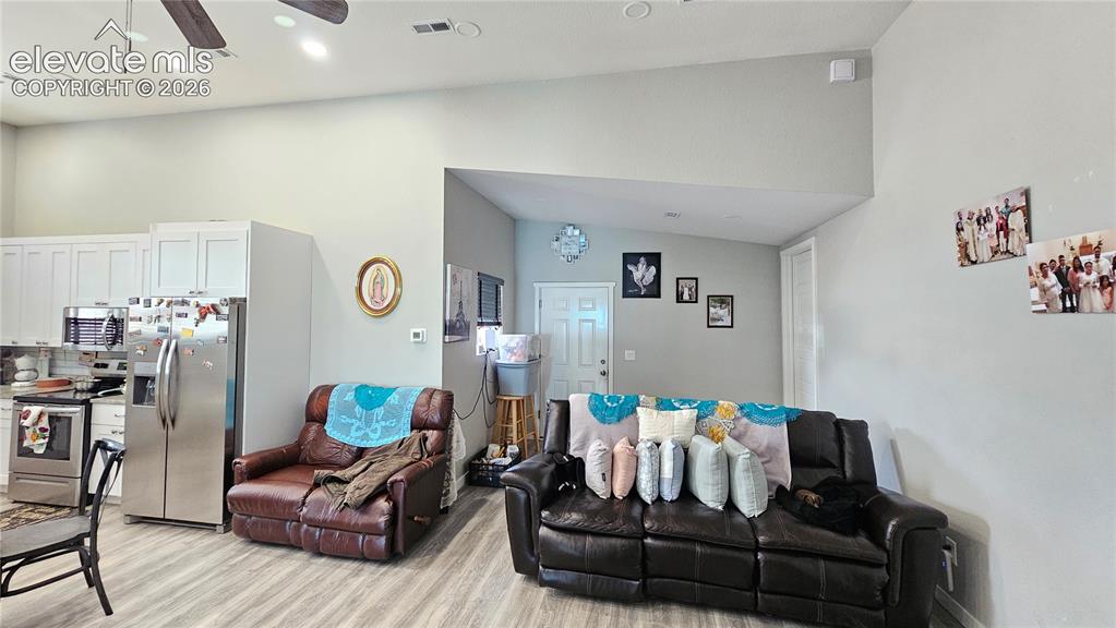 3835 Sengbeil Road Yoder, CO 80864 - Photo 17 of 48 a living room with furniture and wooden floor