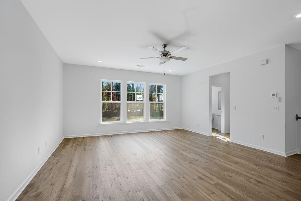 6117 Wayburn Street Tucker, GA 30084 - Photo 13 of 48 a view of an empty room with wooden floor and a window