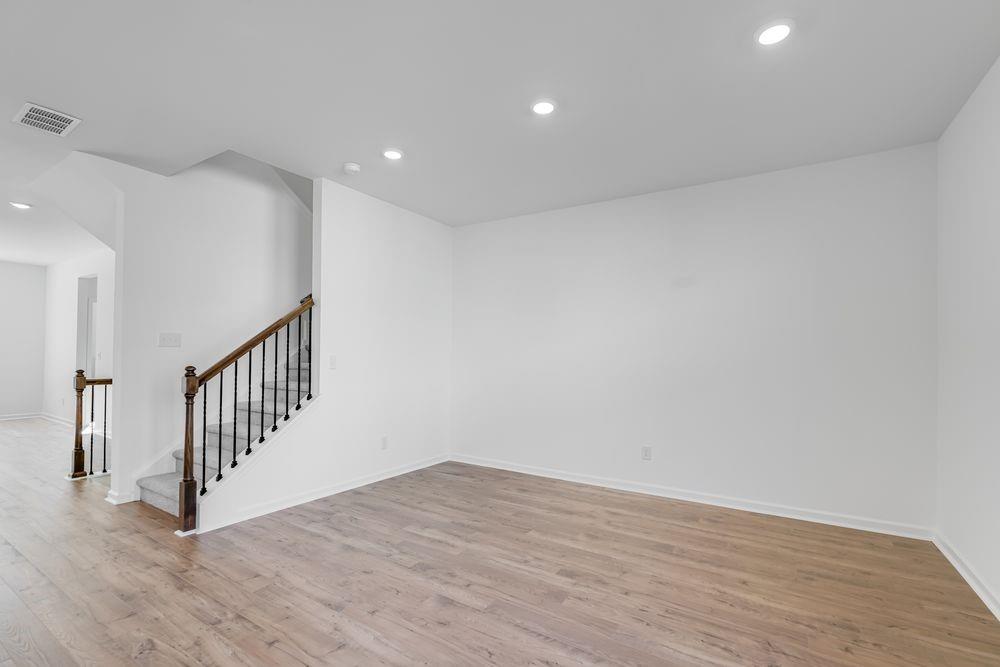 6117 Wayburn Street Tucker, GA 30084 - Photo 15 of 48 a view of an empty room with wooden floor