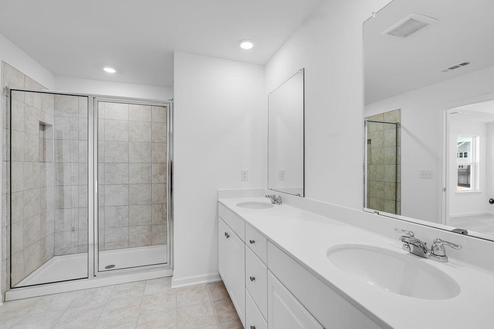 6117 Wayburn Street Tucker, GA 30084 - Photo 24 of 48 a spacious bathroom with a shower sink and mirror