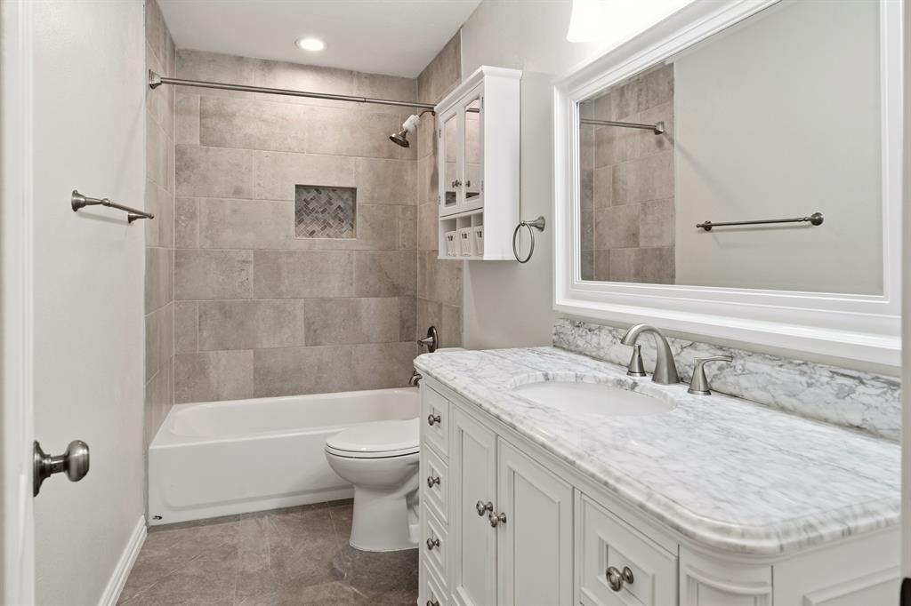 7354 Walling Lane Dallas, TX 75231 - Photo 15 of 28 a bathroom with a granite countertop sink toilet and shower