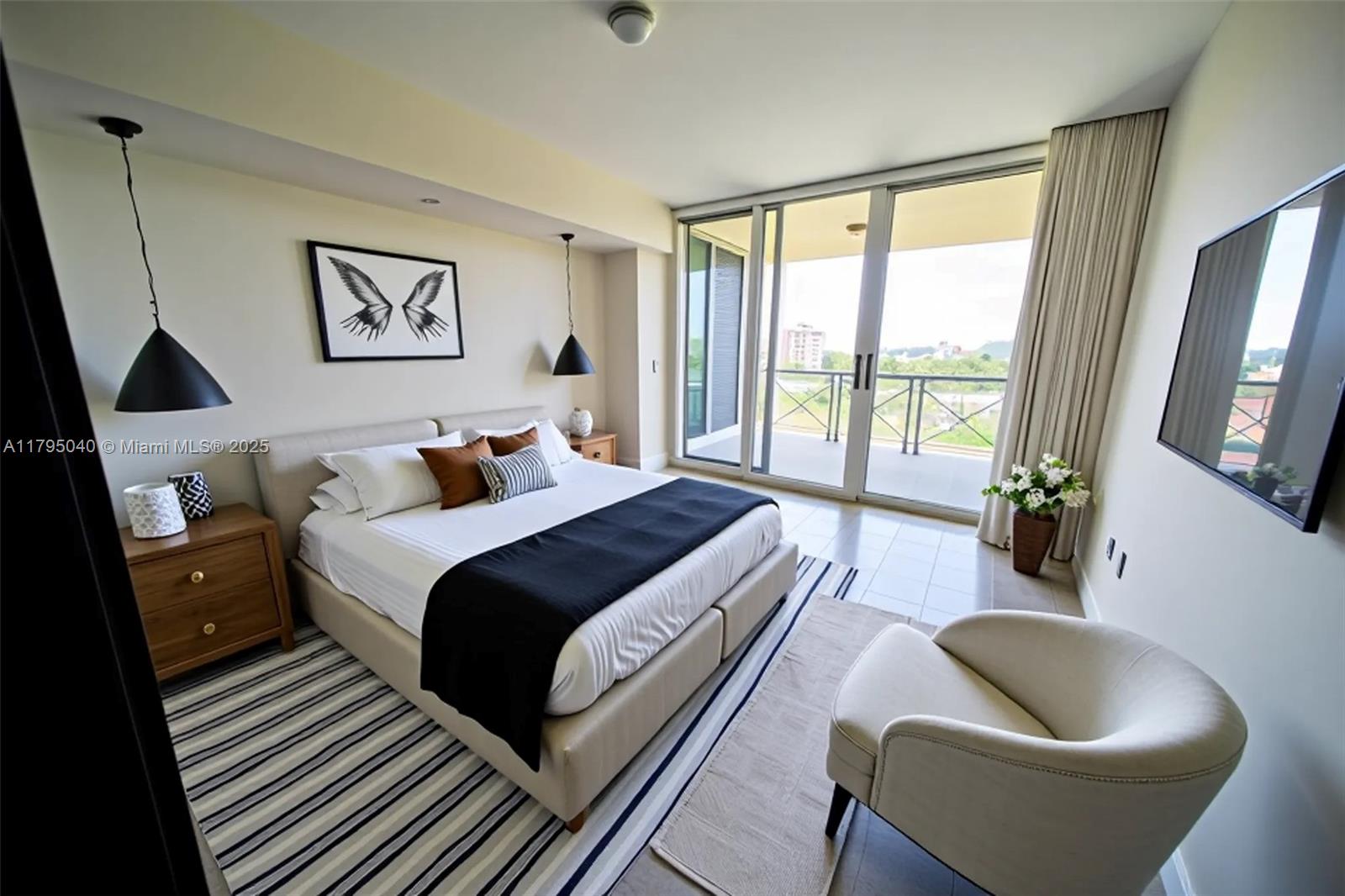 445 Grand Bay Drive, Unit 802 Key Biscayne, FL 33149 - Photo 13 of 24 a bedroom with a bed and wooden floor