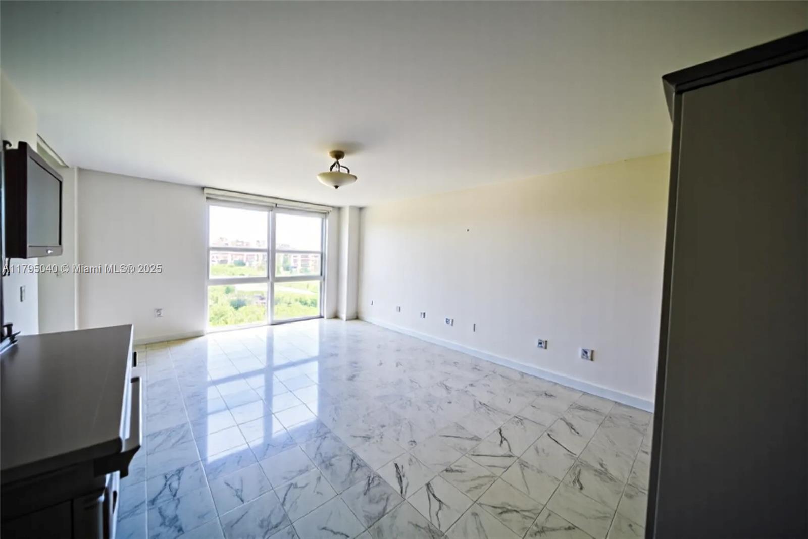 445 Grand Bay Drive, Unit 802 Key Biscayne, FL 33149 - Photo 5 of 24 a view of an empty room with a window