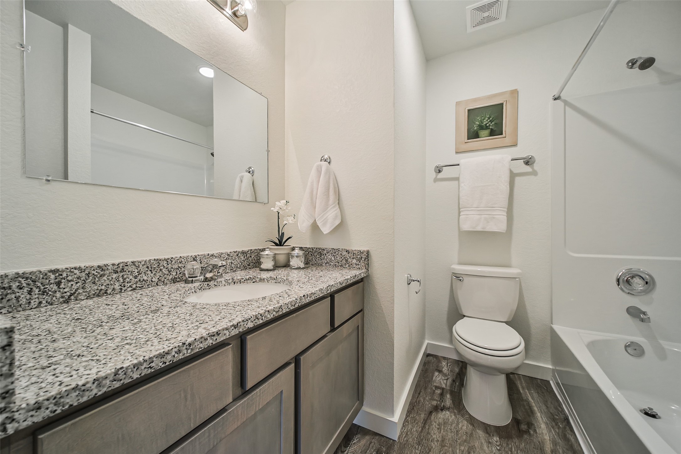 12603 Telge Road, Unit 29A Cypress, TX 77429 - Photo 14 of 31 a bathroom with a granite countertop toilet a sink and a bathtub