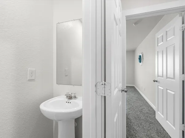 a bathroom with a sink a mirror and a shower