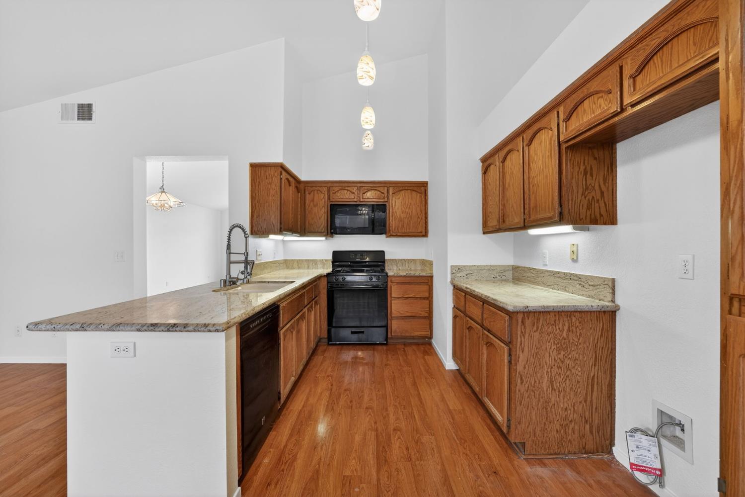 8425 Morning Skye Way Antelope, CA 95843 - Photo 12 of 42 a large kitchen with stainless steel appliances granite countertop a stove a sink dishwasher and a refrigerator