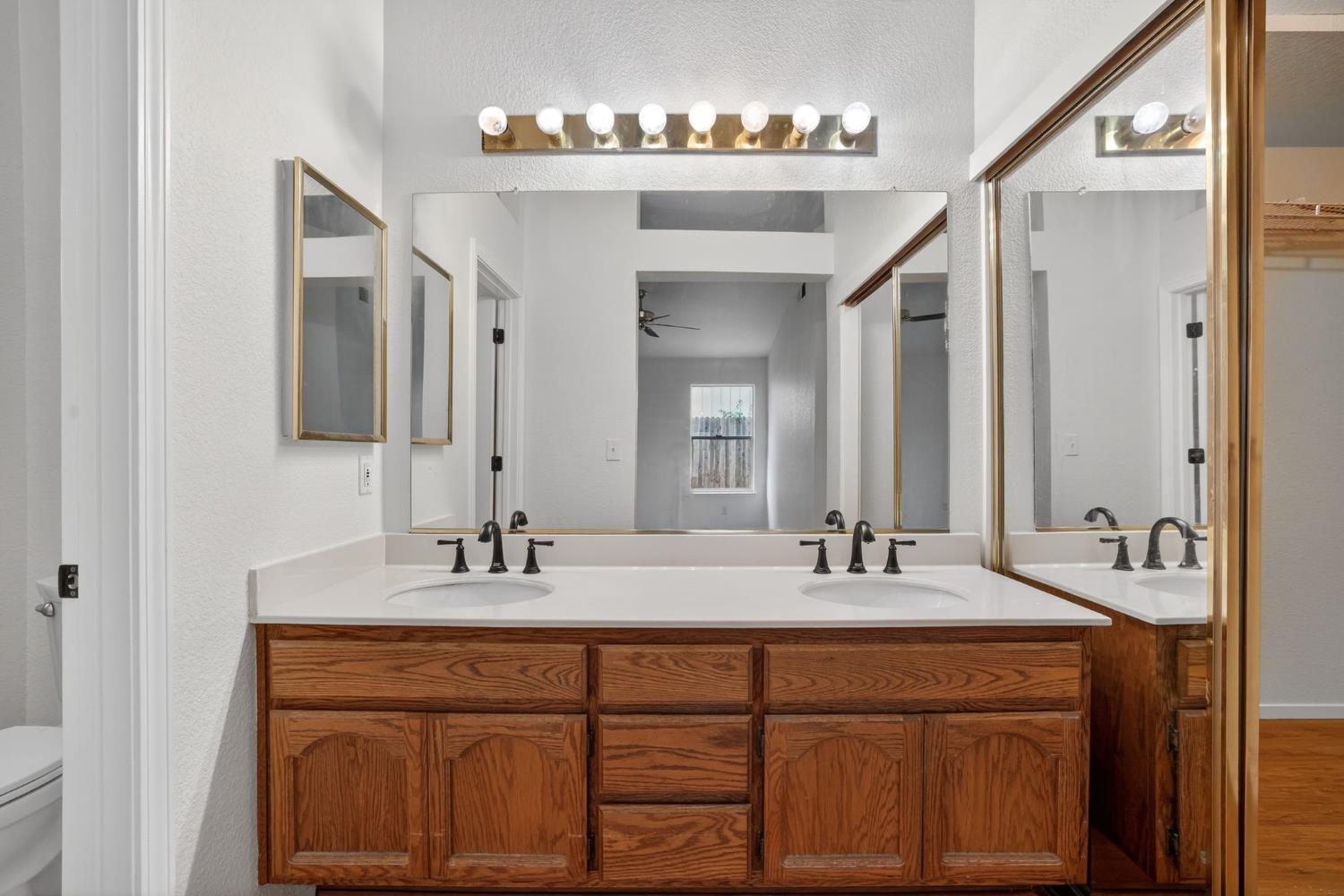 8425 Morning Skye Way Antelope, CA 95843 - Photo 21 of 42 a bathroom with a double vanity sink and a mirror