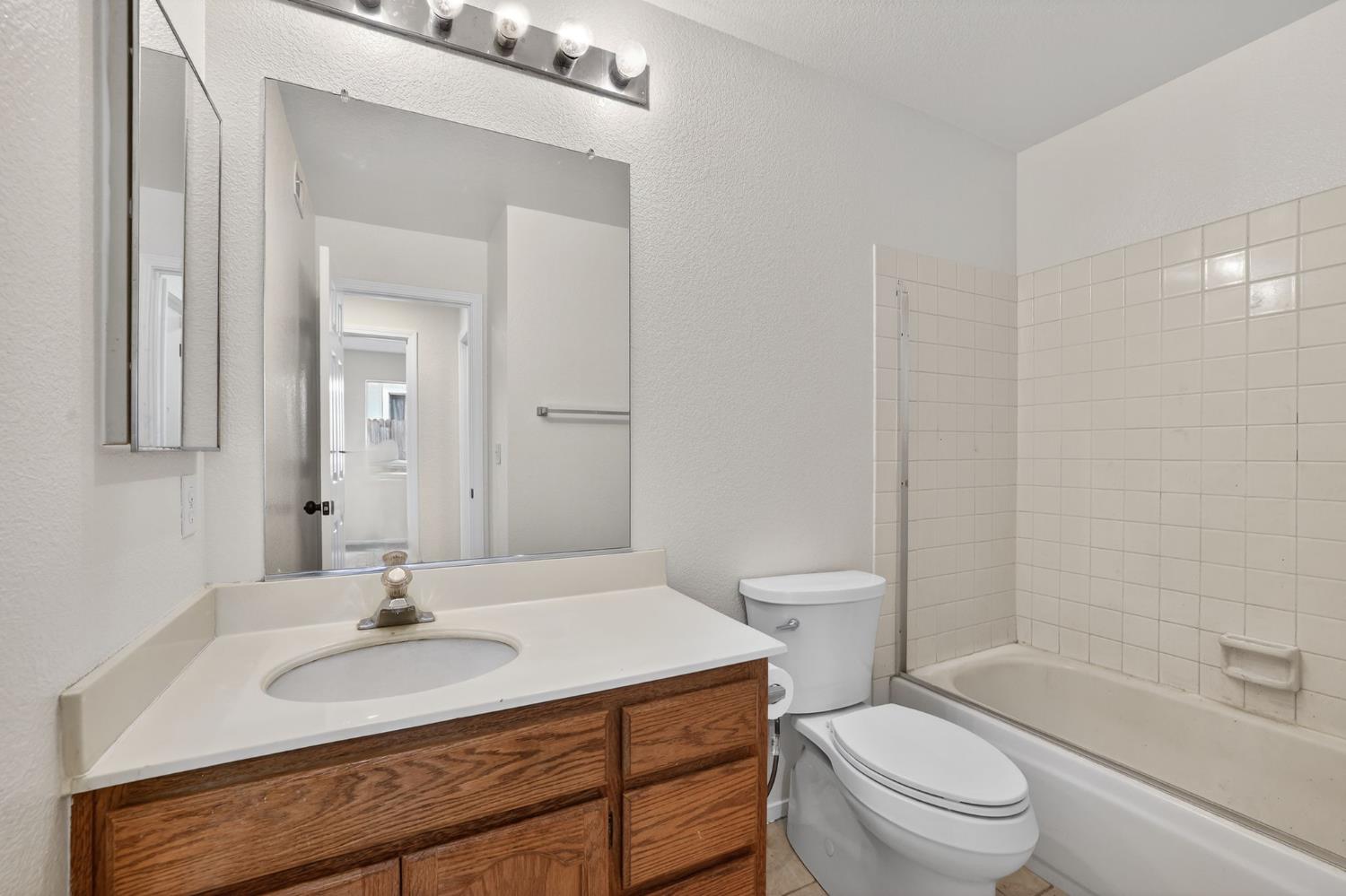 8425 Morning Skye Way Antelope, CA 95843 - Photo 28 of 42 a bathroom with a sink toilet vanity granite tub and shower