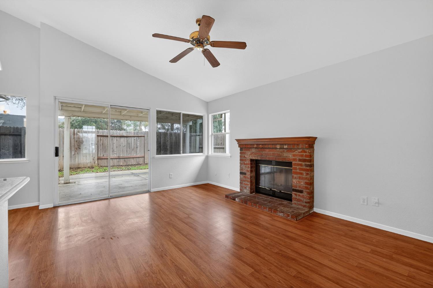8425 Morning Skye Way Antelope, CA 95843 - Photo 8 of 42 a view of empty room with wooden floor and fireplace