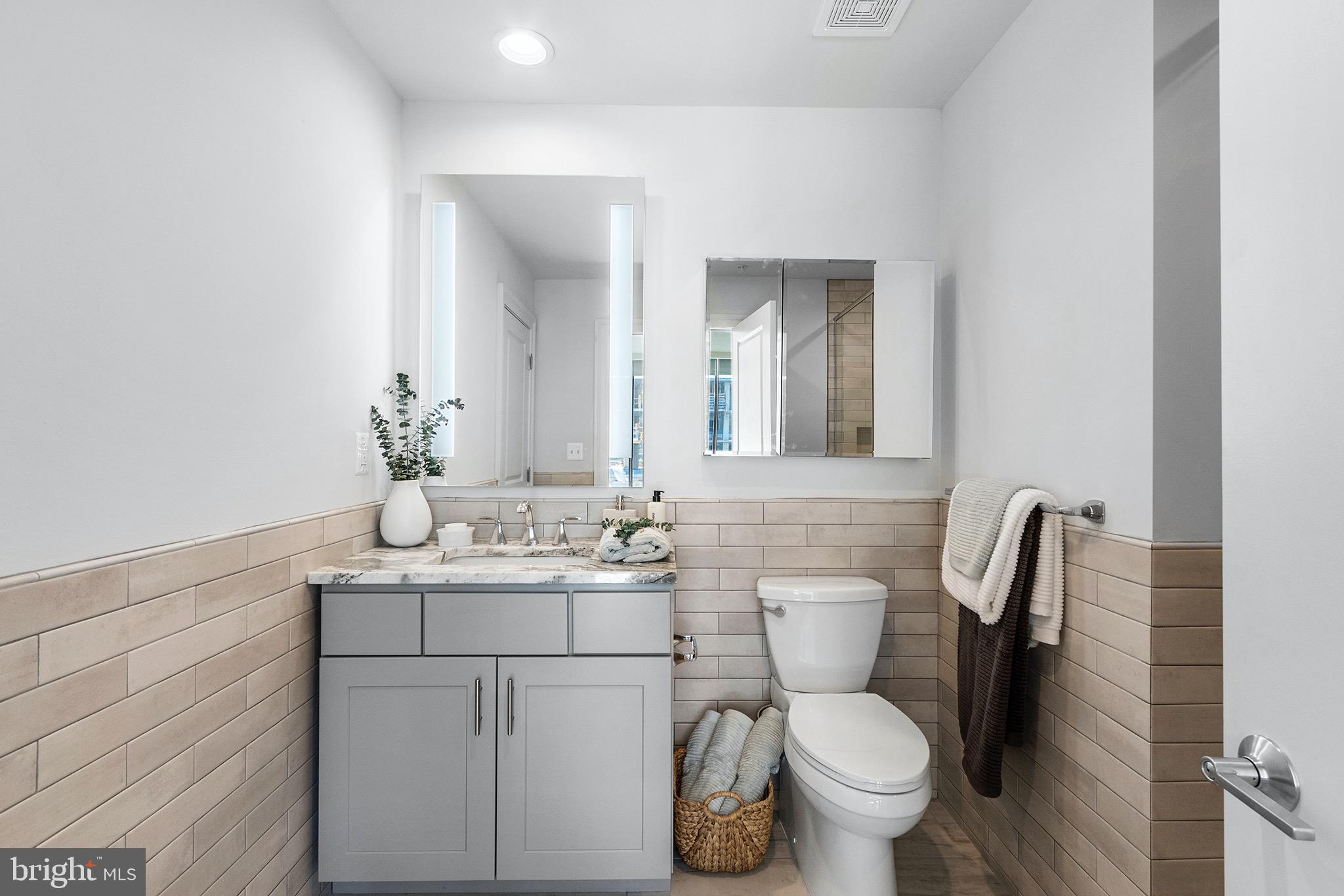 60 North 23rd Street, Unit 906 Philadelphia, PA 19103 - Photo 14 of 31 a bathroom with a toilet sink and mirror