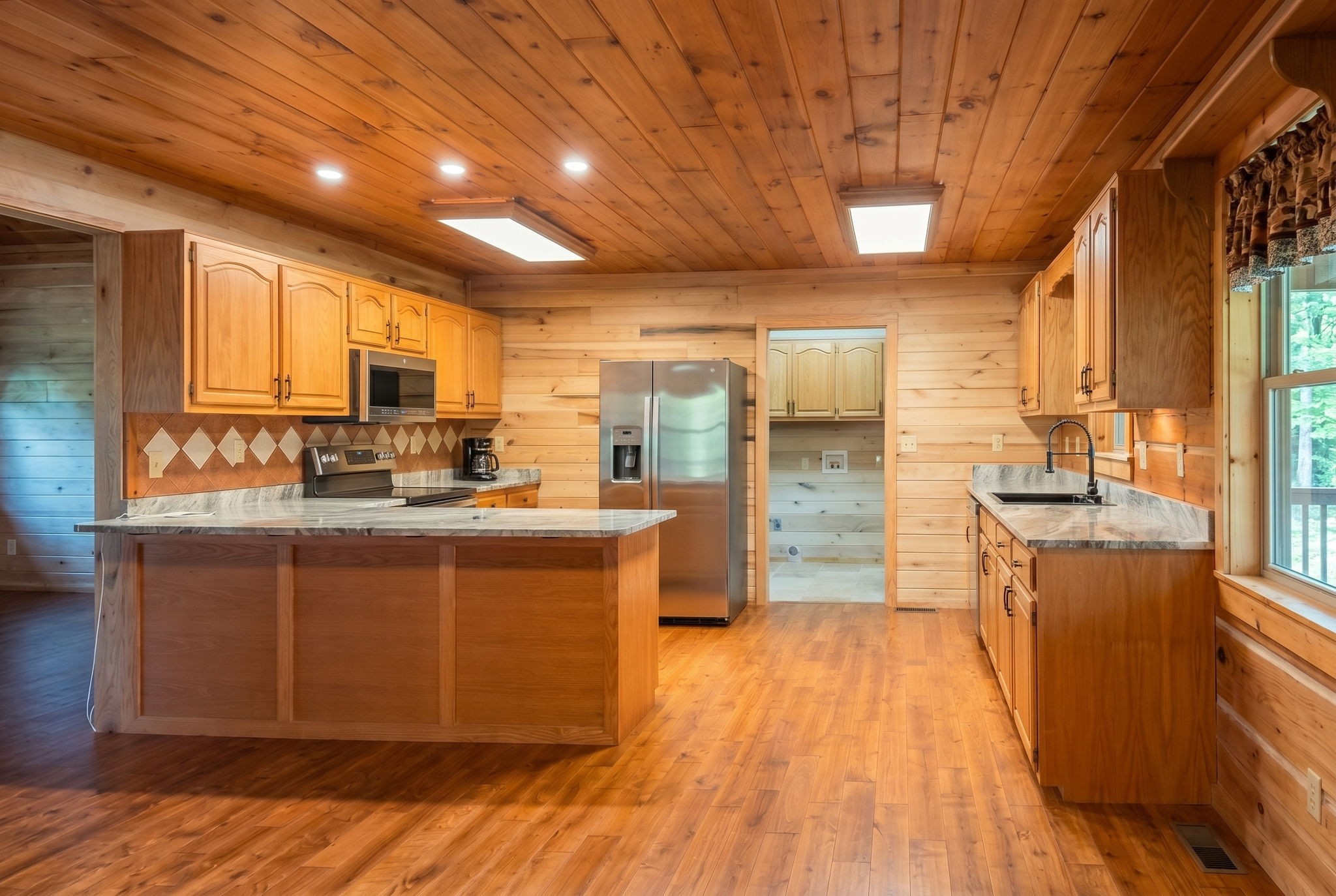 2909 B Beech Log Road Watertown, TN 37184 - Photo 8 of 67 a kitchen with stainless steel appliances granite countertop a stove a sink dishwasher and a refrigerator with wooden floor