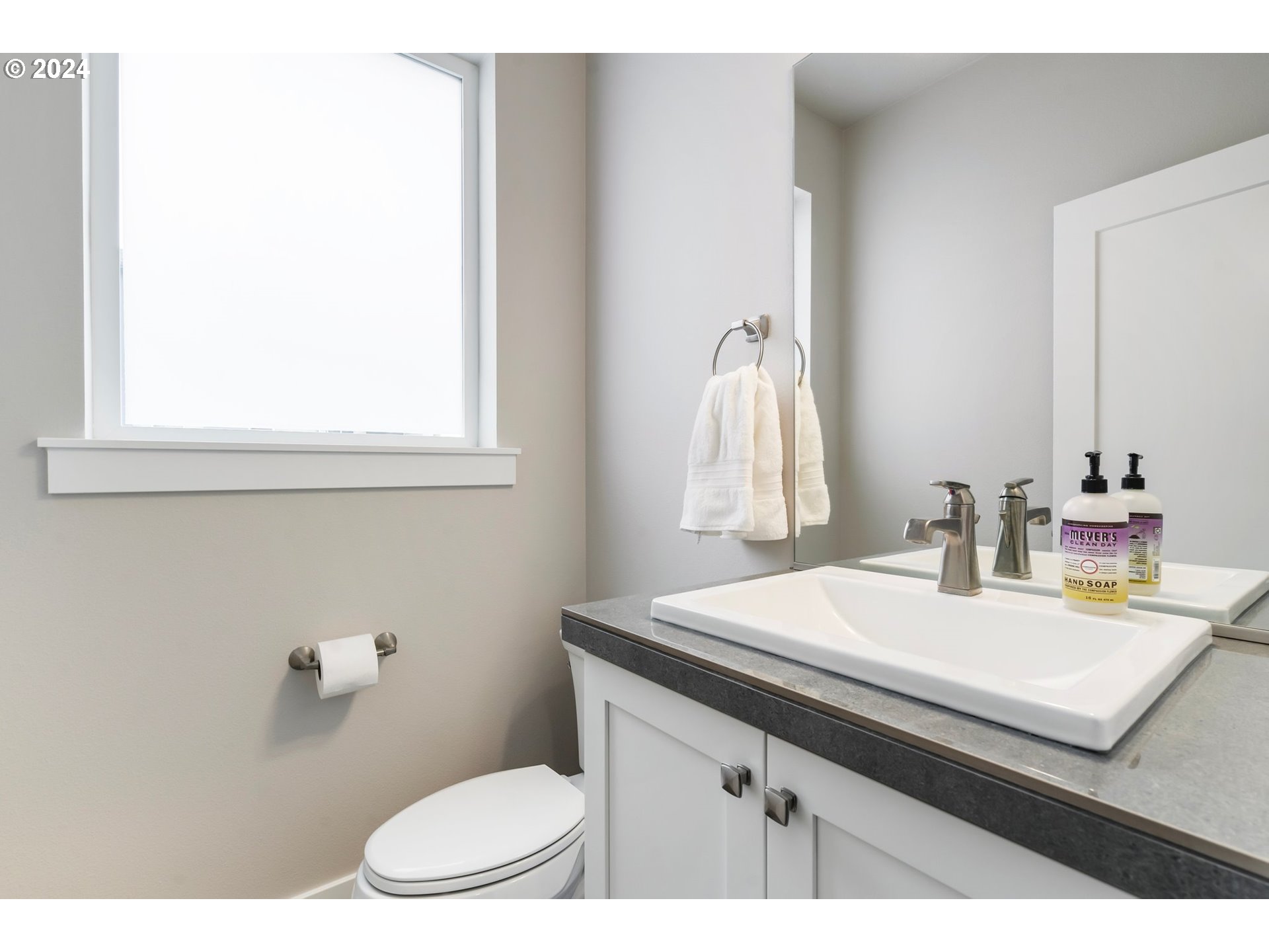 17136 Southwest Woodpecker Lane Beaverton, OR 97007 - Photo 20 of 34 a bathroom with a sink vanity mirror and toilet
