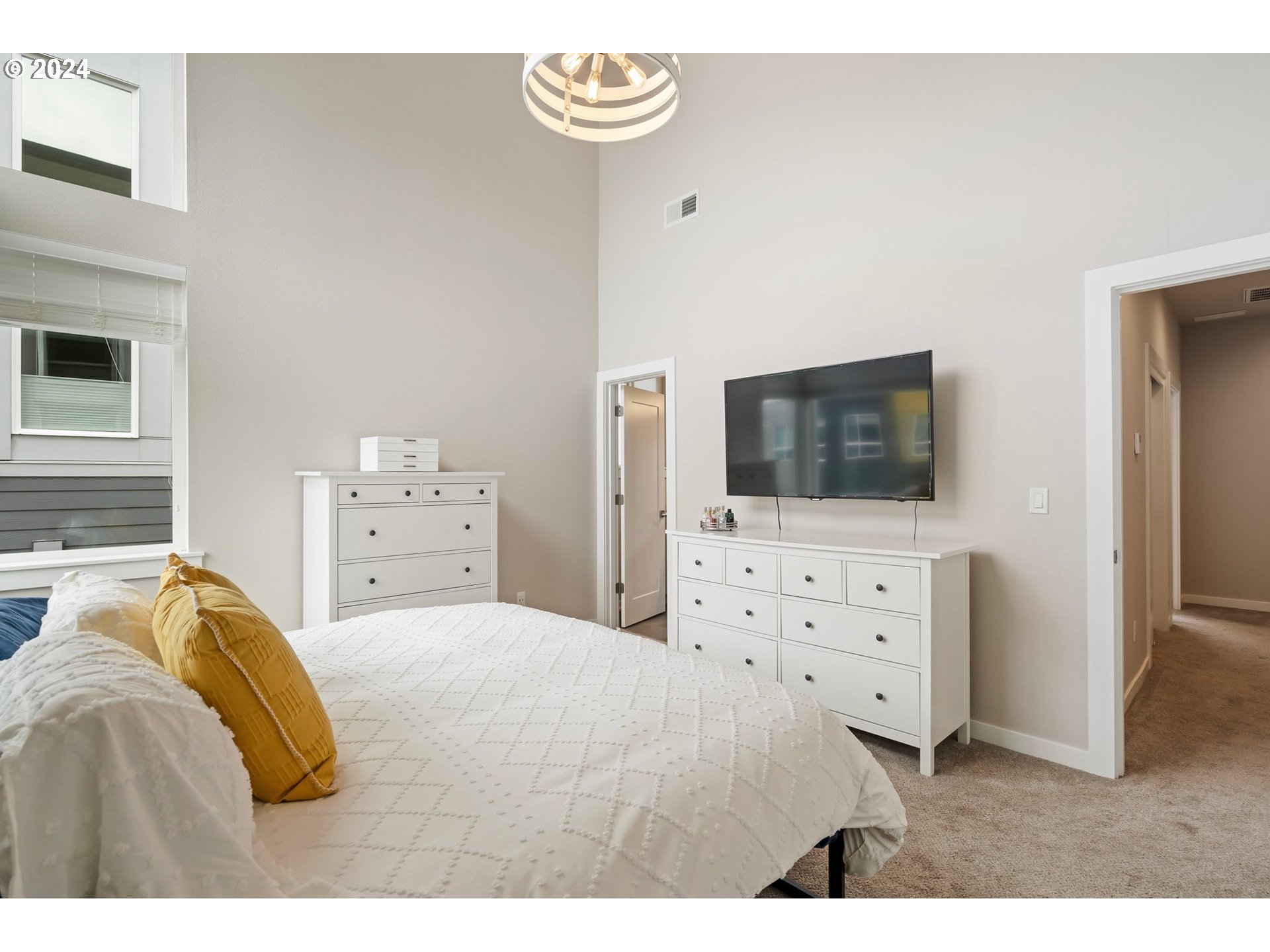 17136 Southwest Woodpecker Lane Beaverton, OR 97007 - Photo 22 of 34 a bedroom with a bed and a flat screen tv