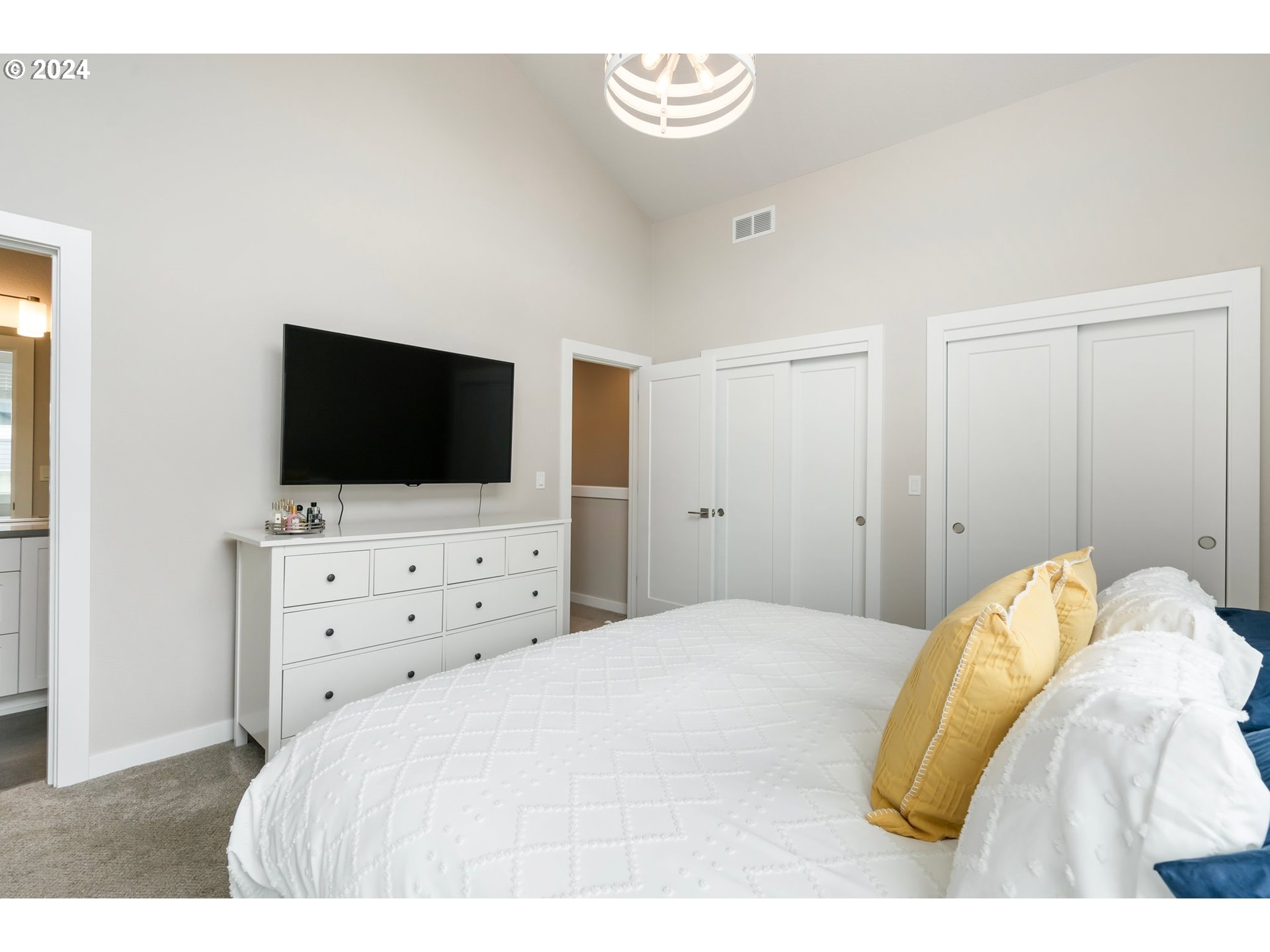 17136 Southwest Woodpecker Lane Beaverton, OR 97007 - Photo 24 of 34 a bedroom with a flat screen tv and a flat screen tv