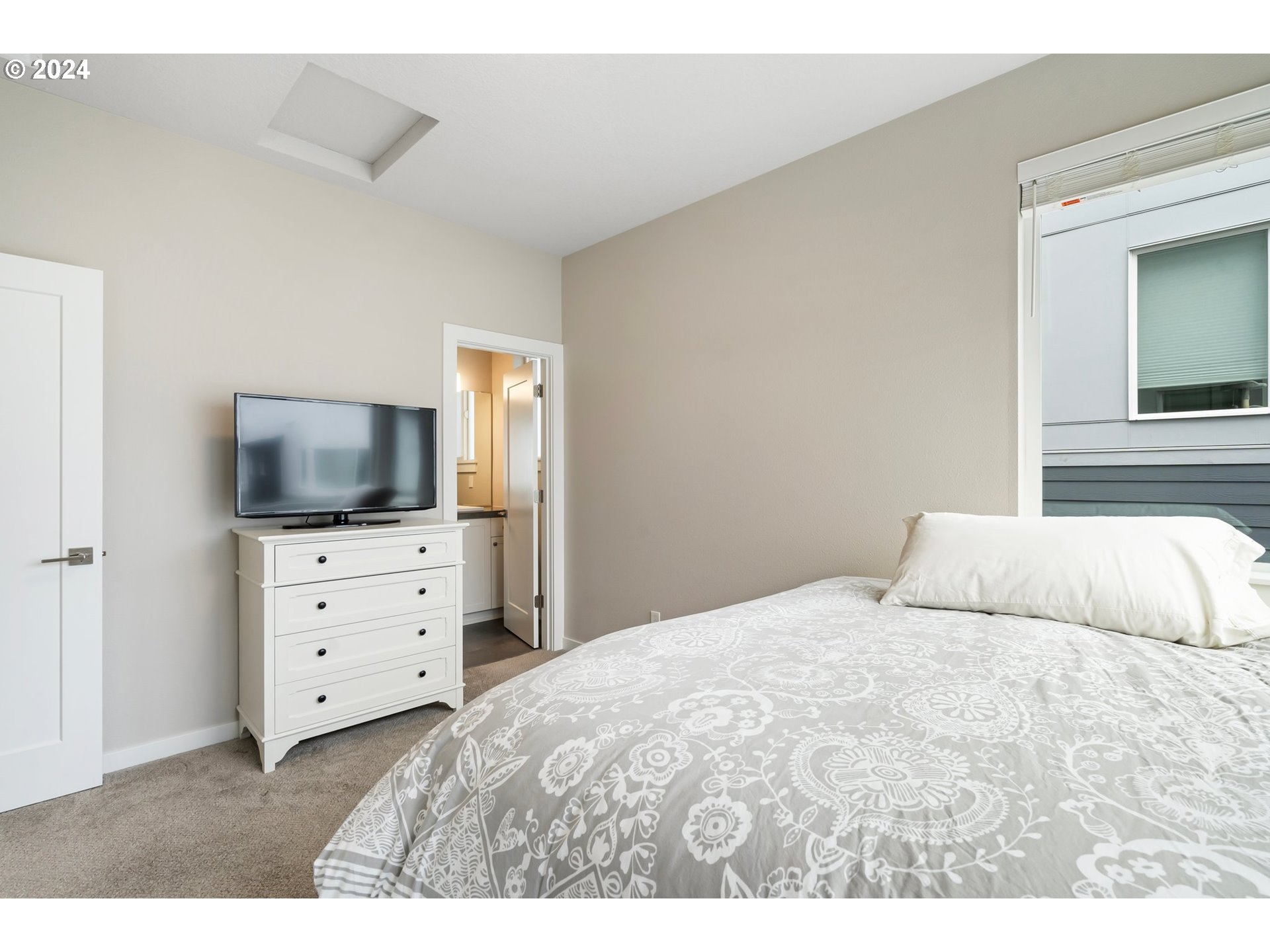 17136 Southwest Woodpecker Lane Beaverton, OR 97007 - Photo 26 of 34 a bedroom with a bed and a flat screen tv