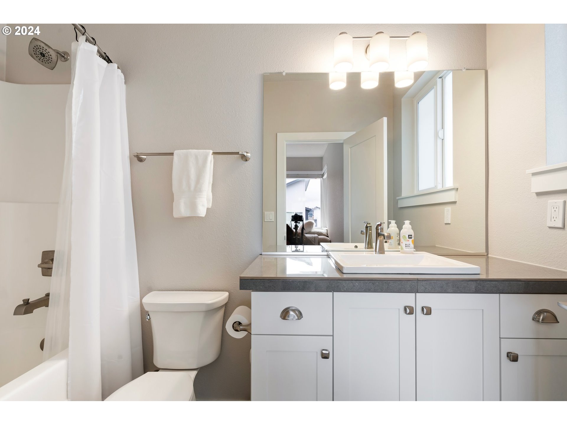 17136 Southwest Woodpecker Lane Beaverton, OR 97007 - Photo 27 of 34 a bathroom with a sink vanity mirror and toilet