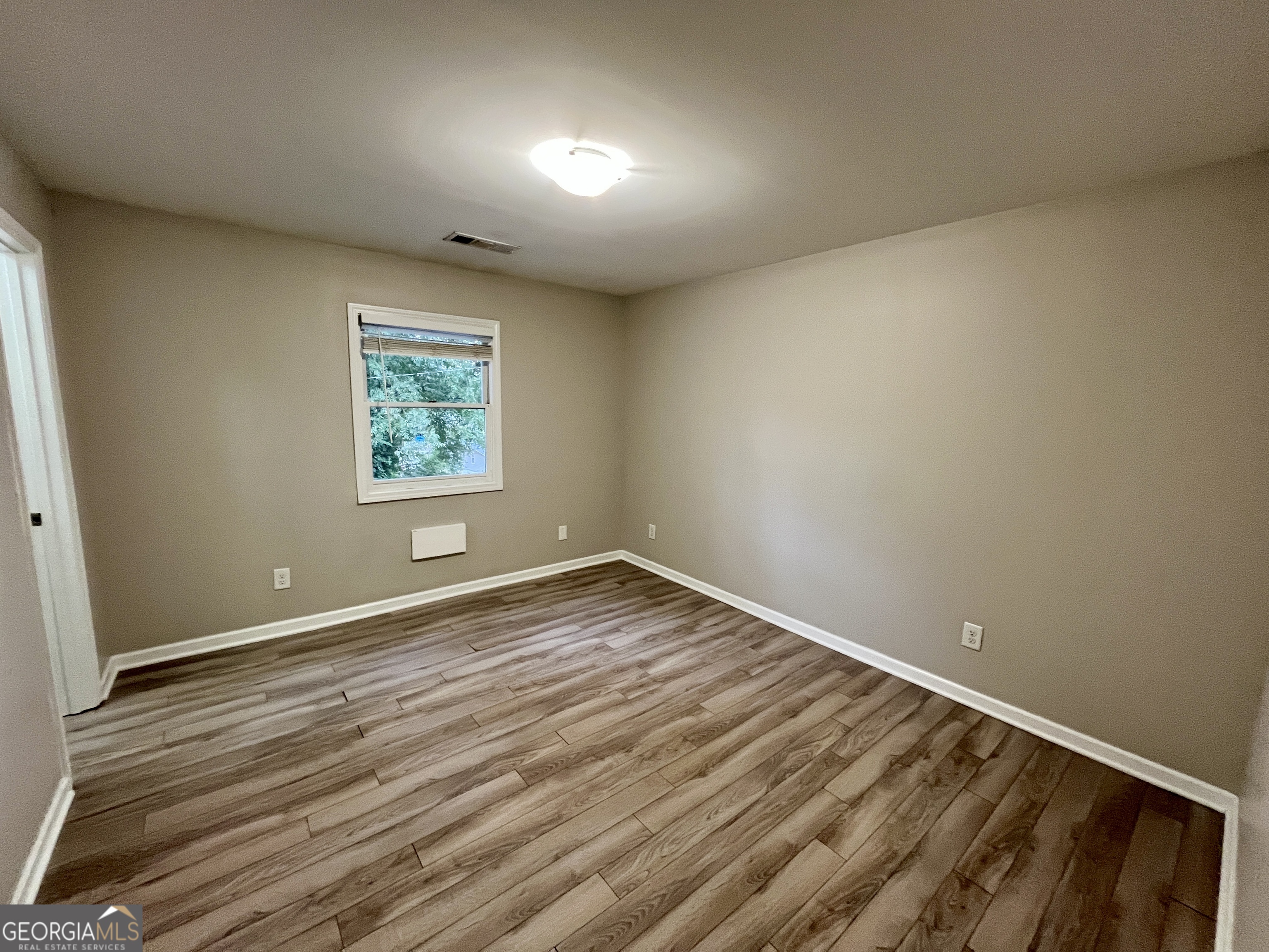 3241 Turner Street, Unit 30 East Point, GA 30344 - Photo 11 of 12 an empty room with wooden floor and windows