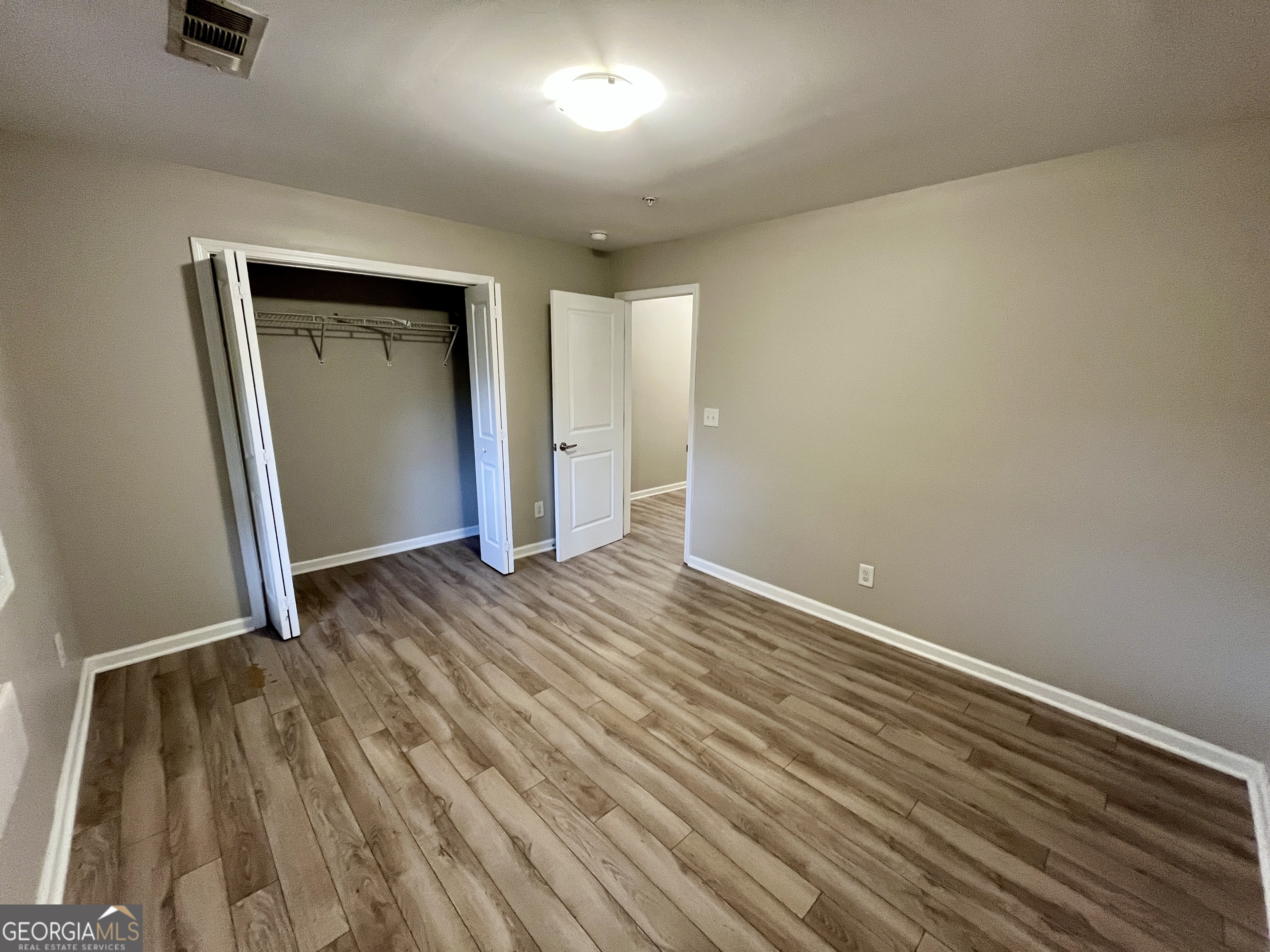 3241 Turner Street, Unit 30 East Point, GA 30344 - Photo 9 of 12 an empty room with wooden floor and closet