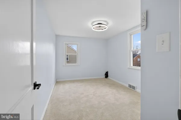 an empty room with windows and closet