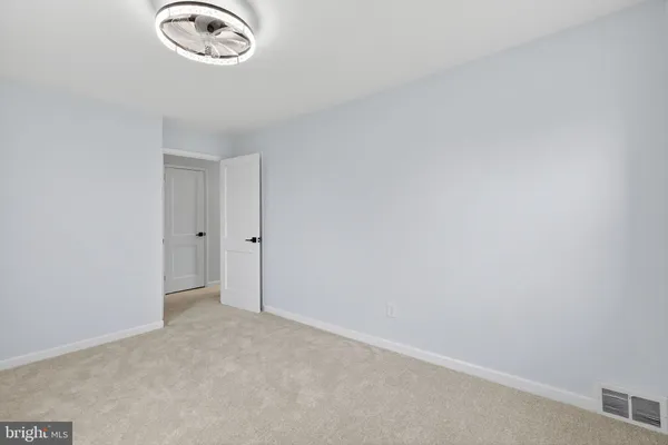 an empty room with a fan