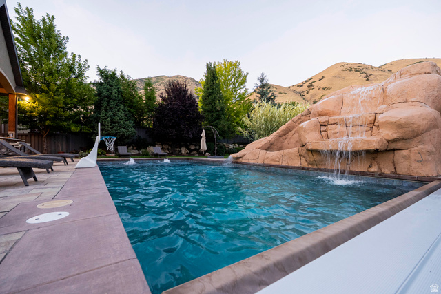 687 South 2080th Street East Springville, UT 84663 - Photo 134 of 149 Outdoor swimming pool with a rock waterfall feature and integrated water jets