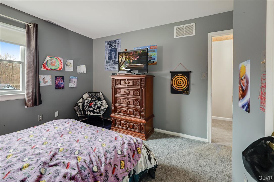 4585 Maple Drive Walnutport, PA 18088 - Photo 15 of 36 a bedroom with a bed and a dresser in it