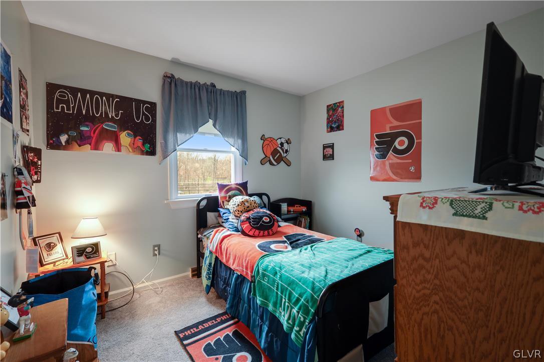 4585 Maple Drive Walnutport, PA 18088 - Photo 16 of 36 a bedroom with a bed and a flat screen tv
