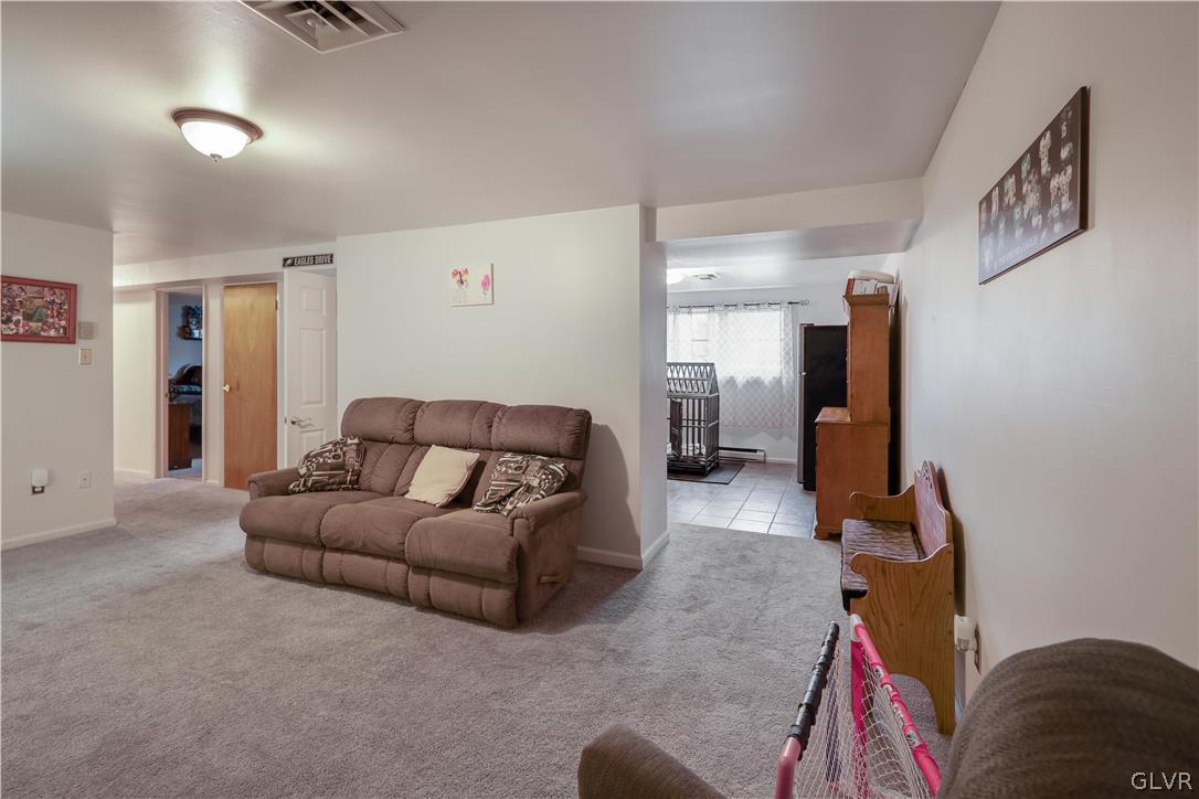 4585 Maple Drive Walnutport, PA 18088 - Photo 20 of 36 a living room with furniture and a flat screen tv