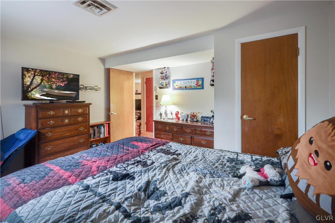 4585 Maple Drive Walnutport, PA 18088 - Photo 22 of 36 a bedroom with a bed and a dresser in it