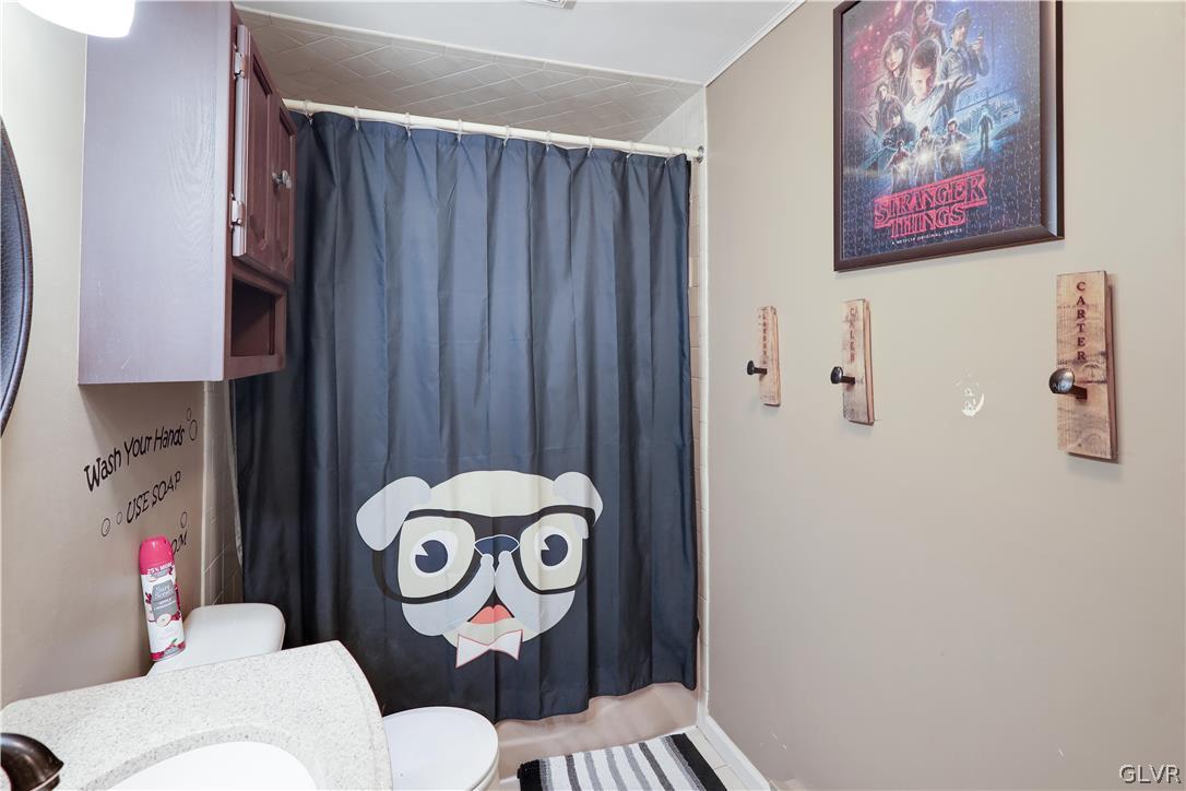 4585 Maple Drive Walnutport, PA 18088 - Photo 23 of 36 a bathroom with a toilet and a painting on the wall