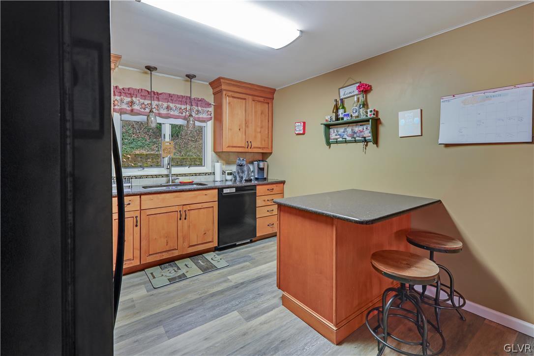 4585 Maple Drive Walnutport, PA 18088 - Photo 5 of 36 a kitchen with granite countertop a stove a refrigerator and a dining table