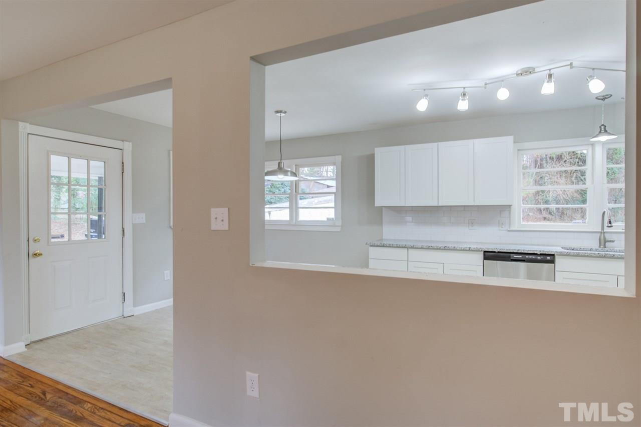 309 Creech Road Garner, NC 27529 - Photo 8 of 30 a kitchen with granite countertop a stove and a refrigerator