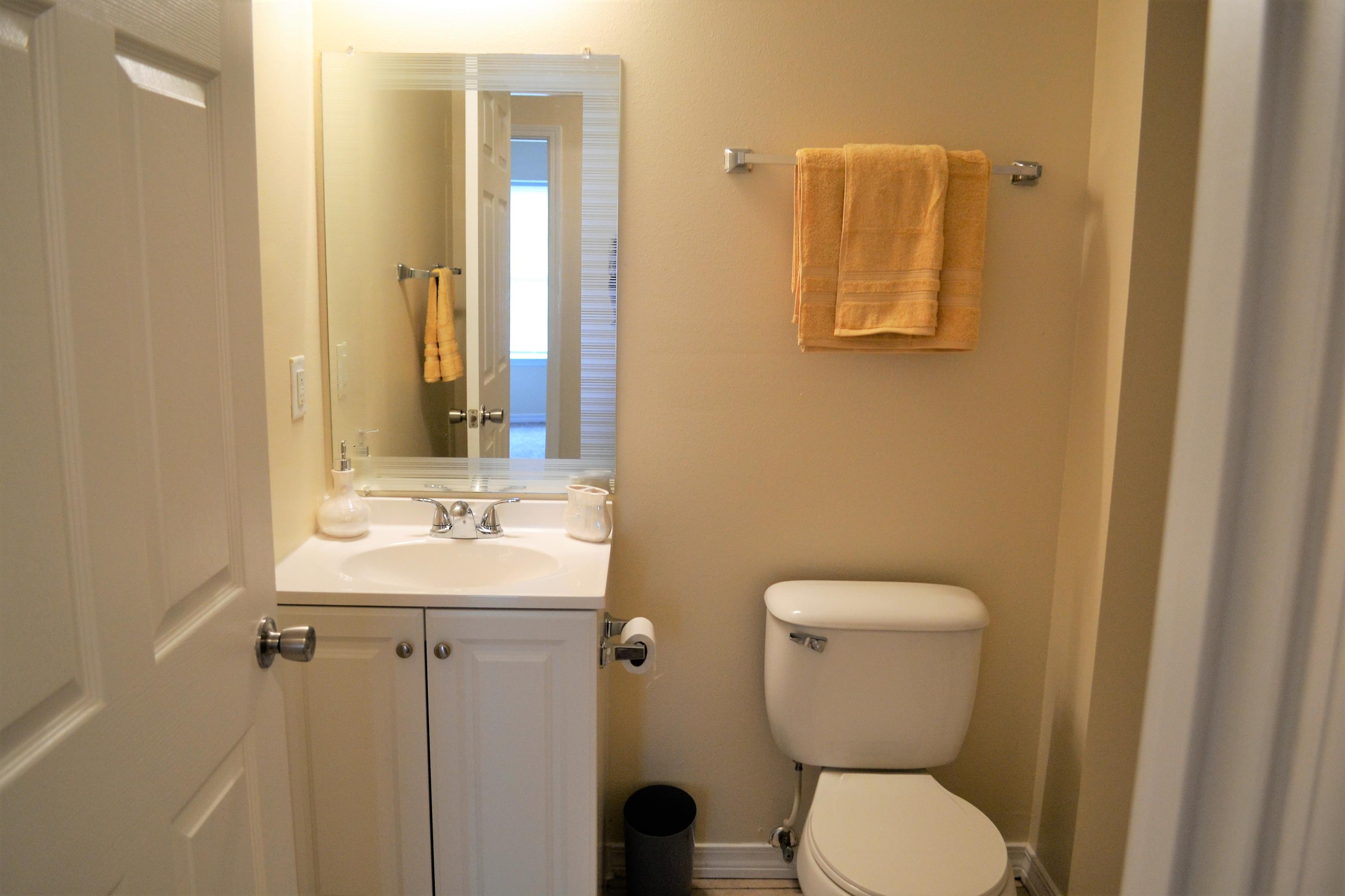 5237 Kervin Road Crestview, FL 32539 - Photo 14 of 28 a bathroom with a toilet sink and mirror