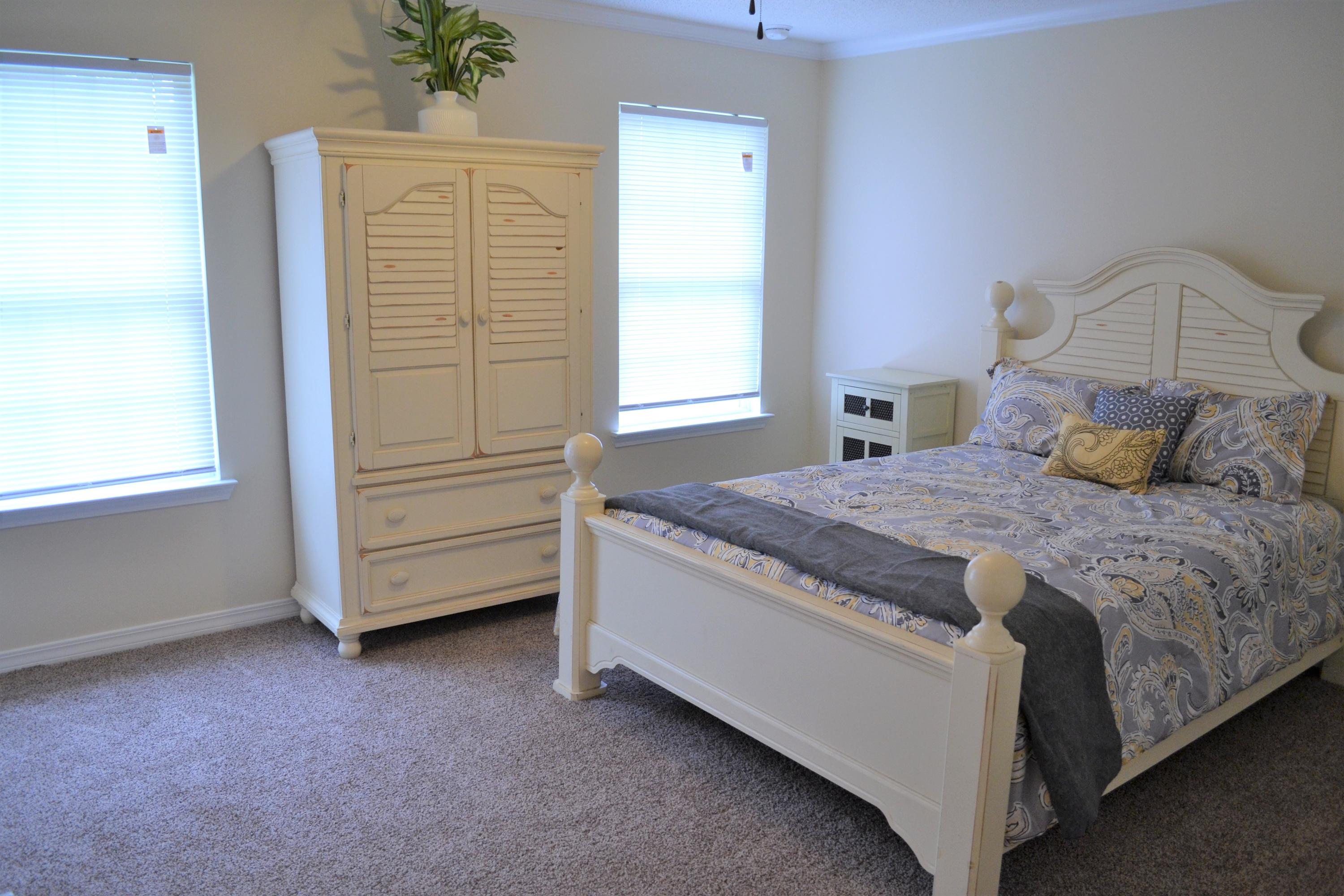 5237 Kervin Road Crestview, FL 32539 - Photo 18 of 28 a spacious bedroom with a bed and a window